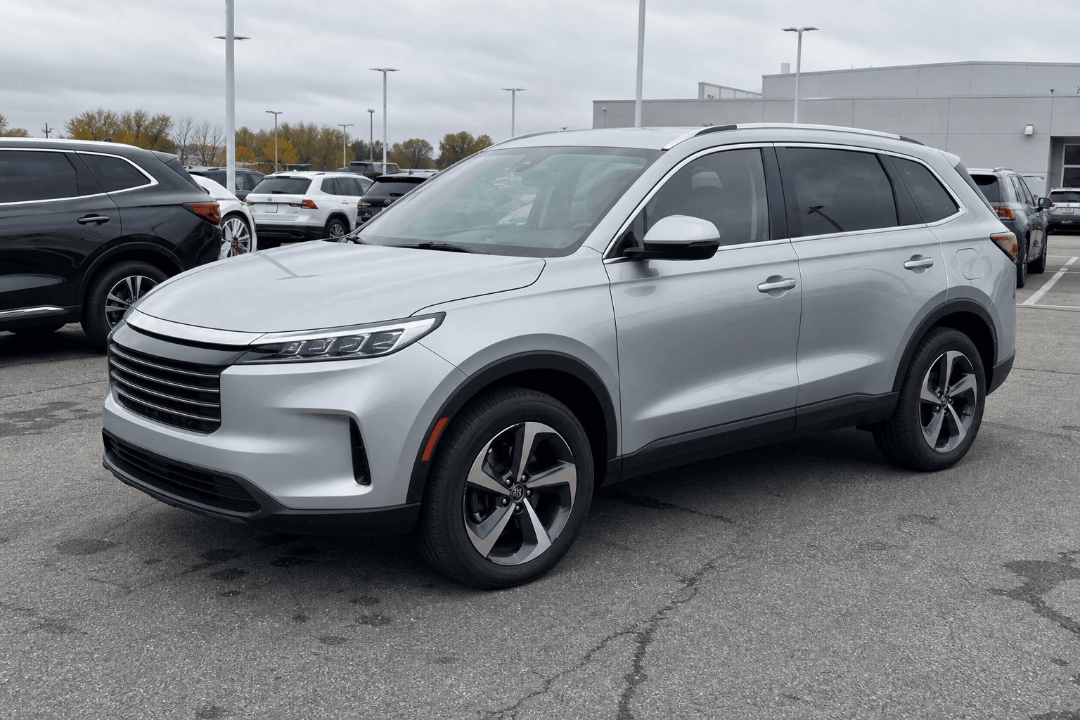 Original dealership lot photo of a silver midsize SUV