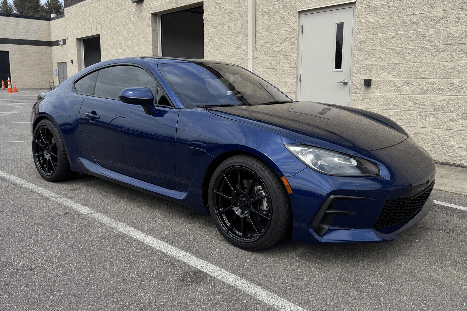 Original dealership photo of a deep blue sport coupe