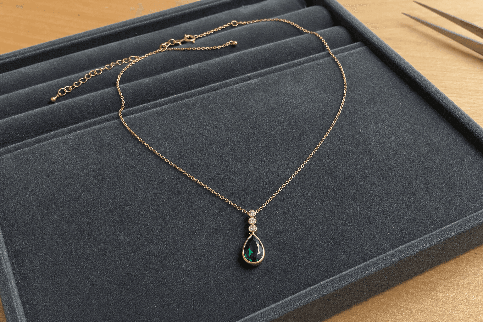 Original jeweler tray photo of a rose-gold emerald necklace